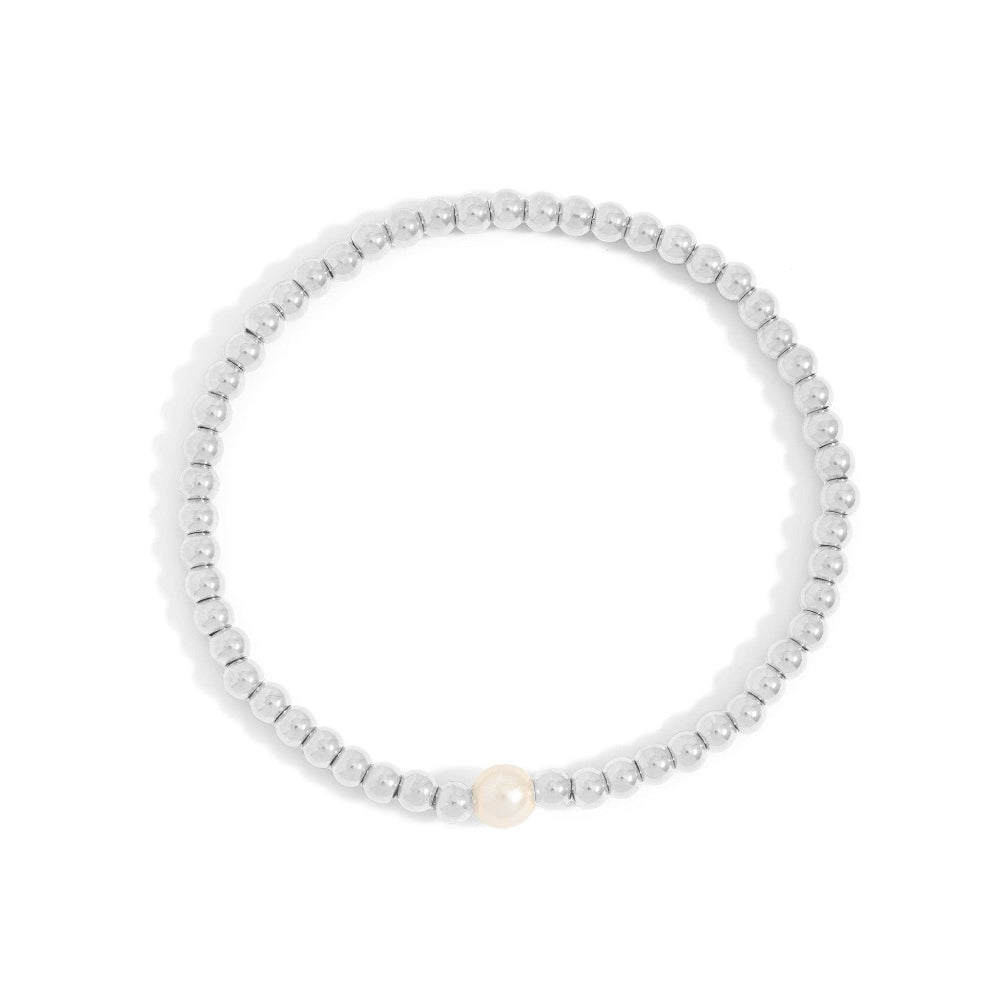Silver beaded bracelet with a single pearl on a white background
