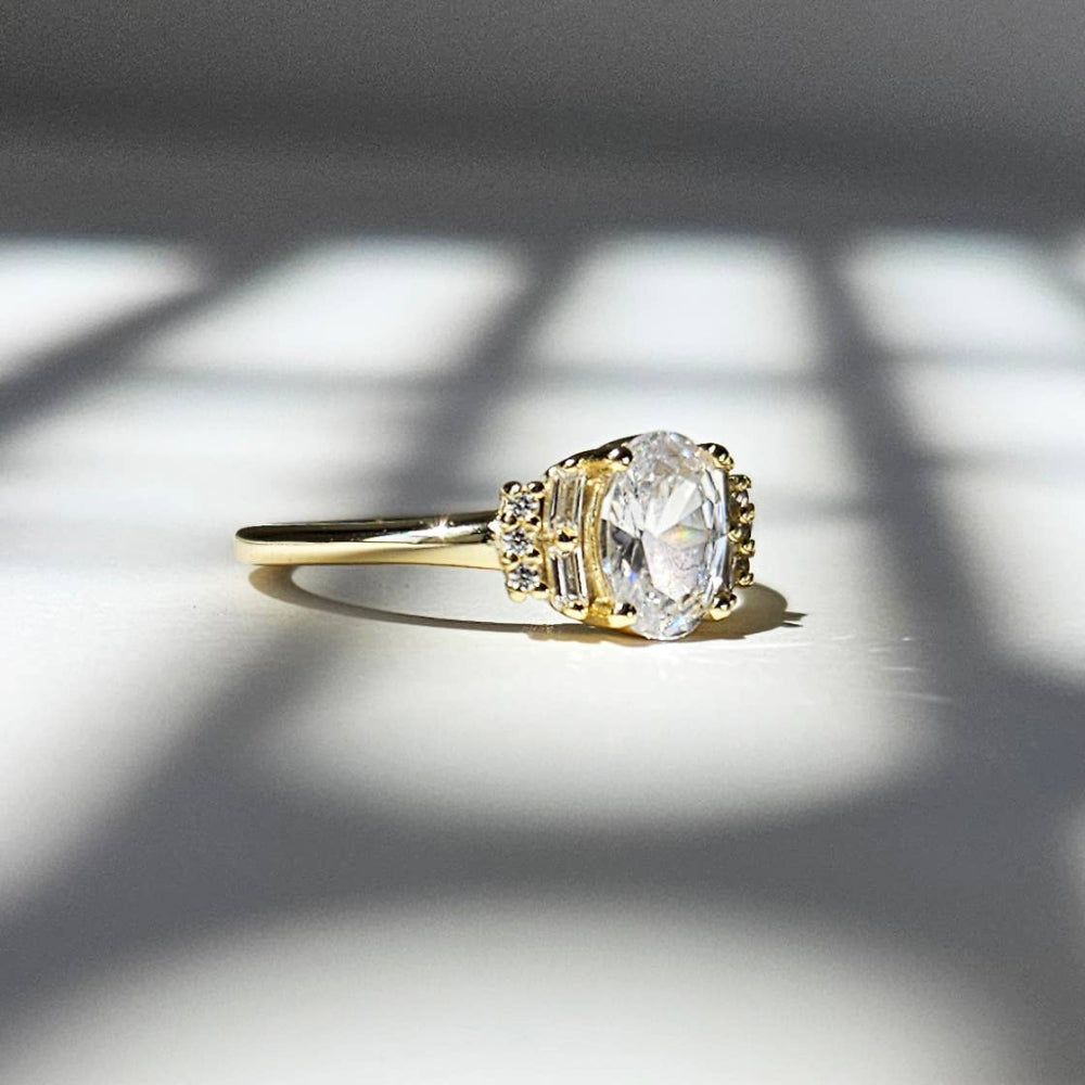 Gold ring with a large diamond on a light background